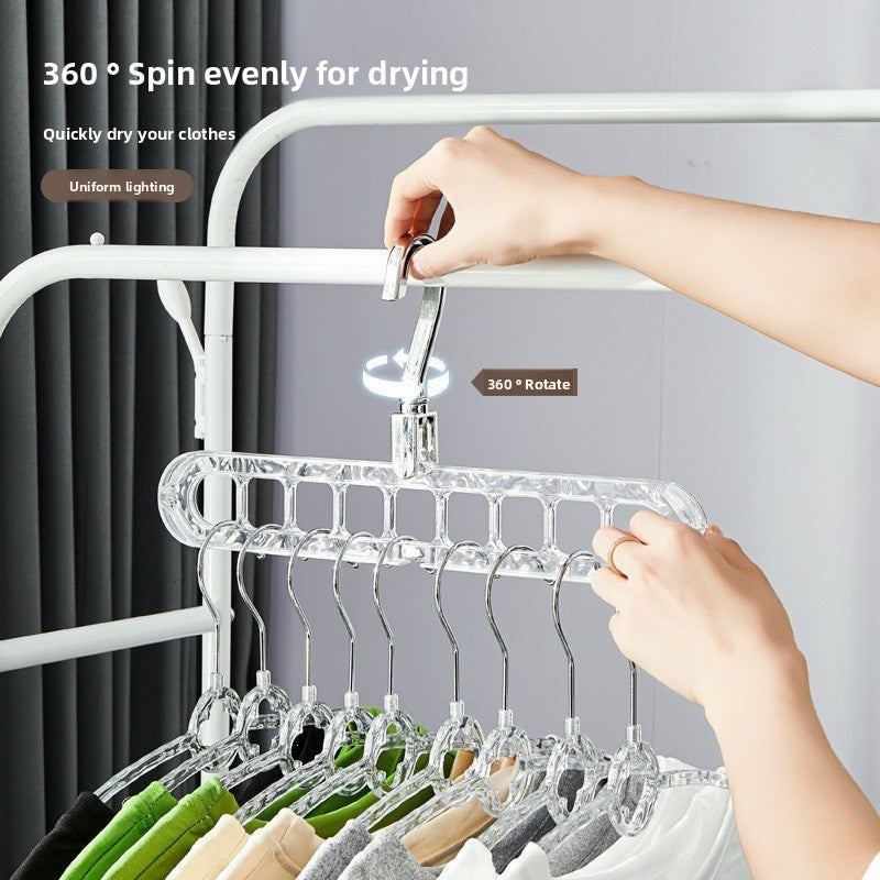 Hand turning the 360 degree rotating hook of a clear nine-hole hanger rack loaded with shirts