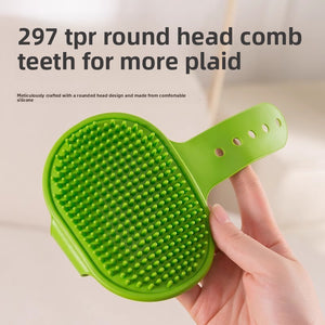Hand holding the avocado green TPR groomer brush showing rows of rounded rubber comb teeth on the oval head