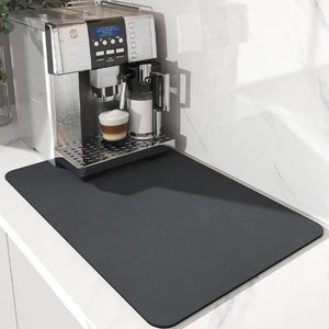 Square diatom mud absorbent mat resting flat on a kitchen counter