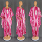 Full length tie dye kaftan maxi dress with high side slits and long sleeves on a model