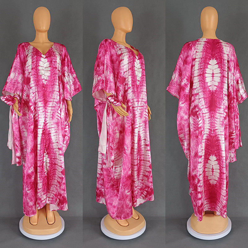 Full length tie dye kaftan maxi dress with high side slits and long sleeves on a model