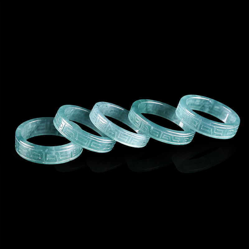 Translucent blue green jadeite band ring with carved antique fret pattern, close view