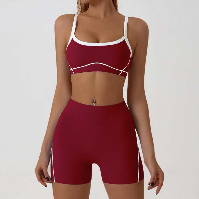 Front view of the sling strap sports bra with scoop neck and fine contrast piping on the bust