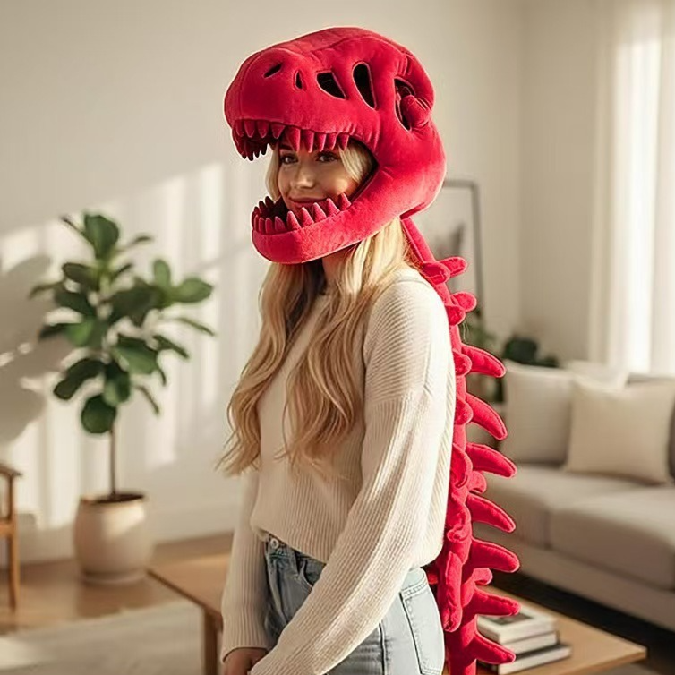 Woman wearing a red plush dinosaur skeleton head mask with a long red spine down her back
