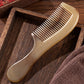 Full length view of the marbled amber plastic hair comb on a plain studio background