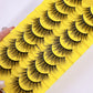 Thick fluffy cat eye false strip eyelashes in black on a yellow ten pair tray, one full yellow tray of ten pairs