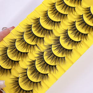 Thick fluffy cat eye false strip eyelashes in black on a yellow ten pair tray, one full yellow tray of ten pairs