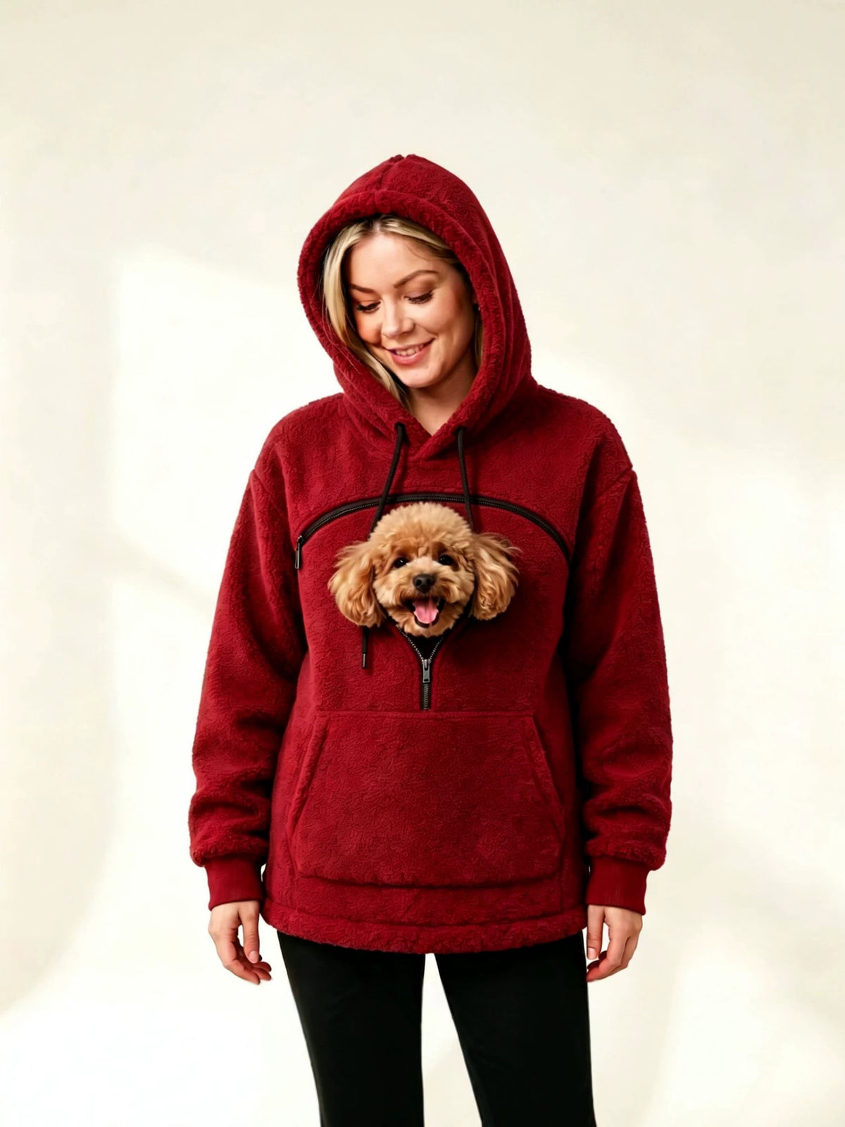 Dark red teddy fleece hoodie with the hood up and a small dog's head showing through the chest opening