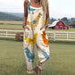 Loose overall jumpsuit worn over a tee, button straps and rolled cuffs