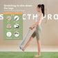 Wide fabric yoga stretching strap with a bar handle and a foot loop used standing to reach a raised foot