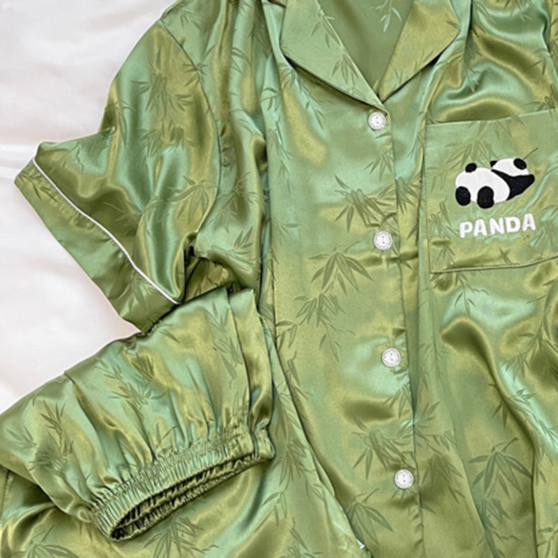 Green pajama shirt sleeve with white piping beside the elastic shorts hem and front button row
