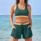 Womens two piece color block swim set worn on the beach, racerback tank top and matching shorts