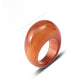 Carnelian stone ring carved solid, shown angled on a plain background