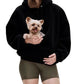 Small dog resting in the front kangaroo pouch of the pink plush fleece hooded sweatshirt