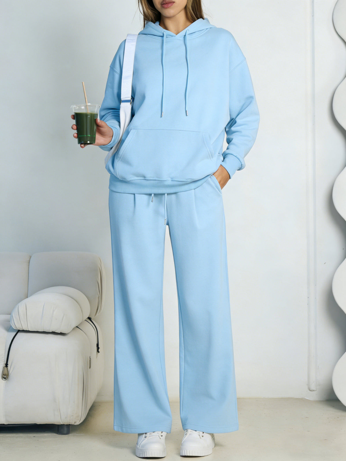 Light blue fleece hooded sweatshirt and wide-leg sweatpants set worn by a model