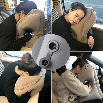 Person leaning forward and resting on a gray inflatable travel pillow with a face opening, with a close view of the air valve in the center