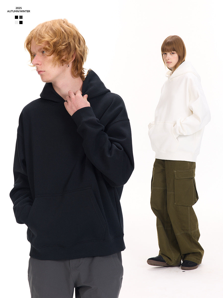 A man in a navy pullover hoodie and a woman in a white hoodie standing side by side against a white background