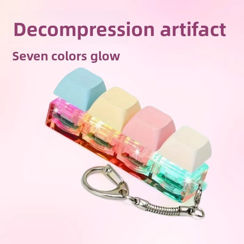 Pastel keycap clicker keychain with colorful lit switches on a pink gradient