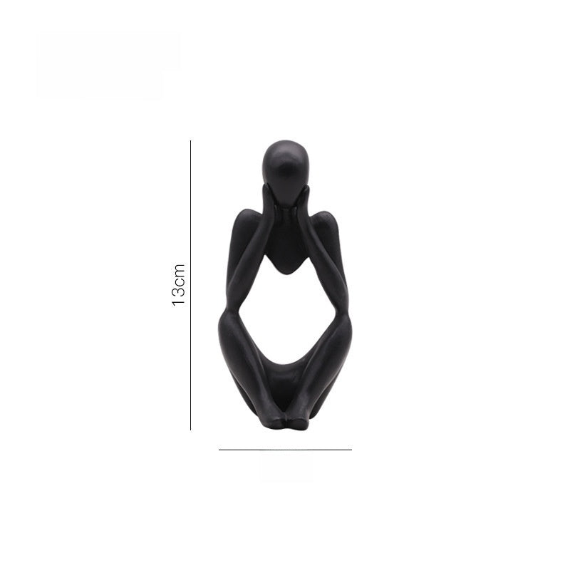 Matte black abstract resin meditator figurine in a calm seated thinking pose for home decor