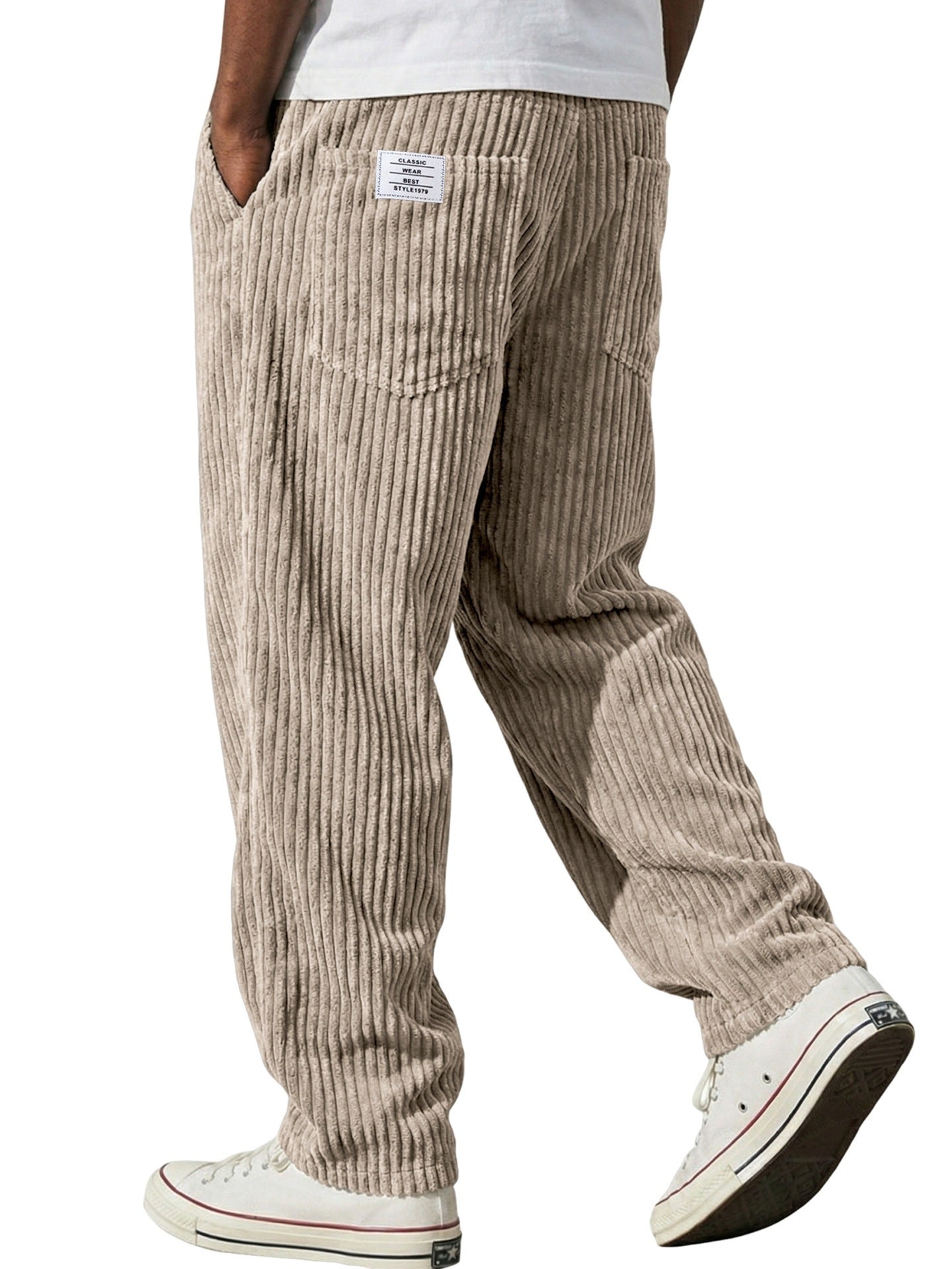 Corduroy trousers worn with a plain tee to show the relaxed straight leg cut