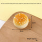 Golden bun squishy keychain clipped to a bag for a playful charm