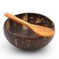 Natural coconut shell bowl with a coconut wood spoon resting across the rim