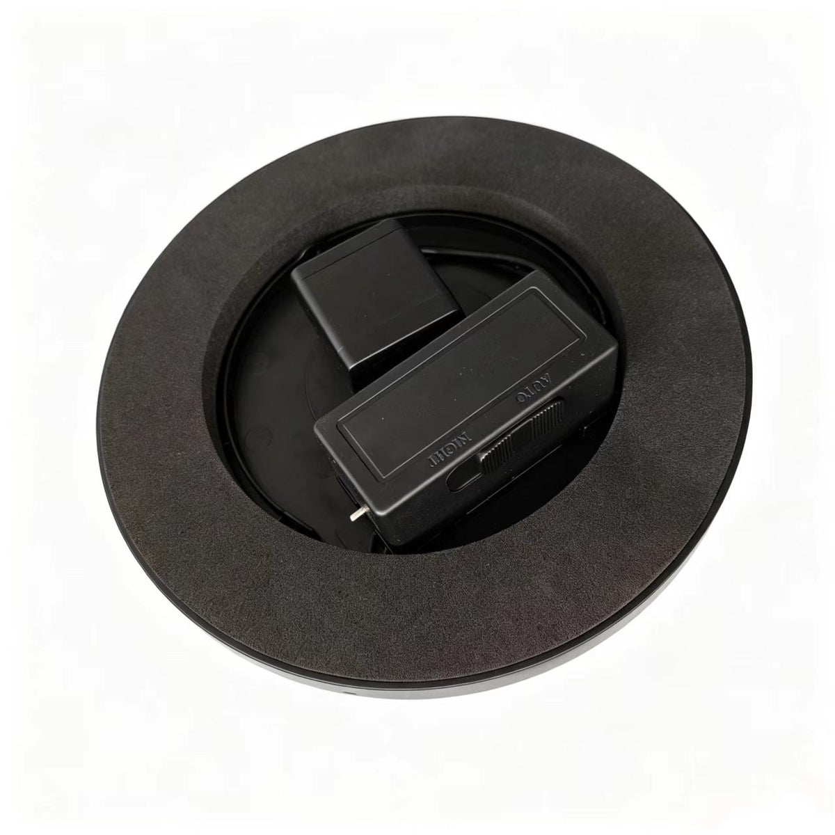 Underside of the solar fountain float showing the pump and a battery box inside a dark foam ring