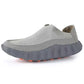 Light gray perforated slip-on loafer with a slate gray scalloped sole and orange tread nubs, side view on white