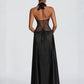 Back of the black gown showing the open back and lace up corset tie at the waist