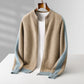 Camel wool zip cardigan with light blue sleeves and ribbed cuffs hanging open over a white tee