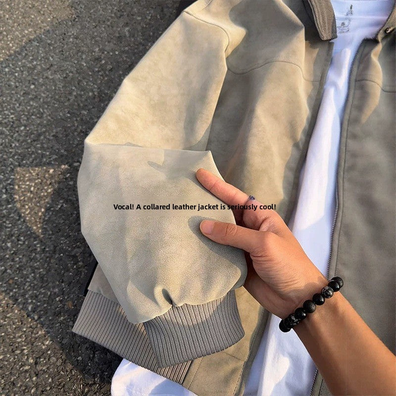 Close-up of the rib knit cuff and sleeve of the beige tie-dye PU leather jacket held in one hand