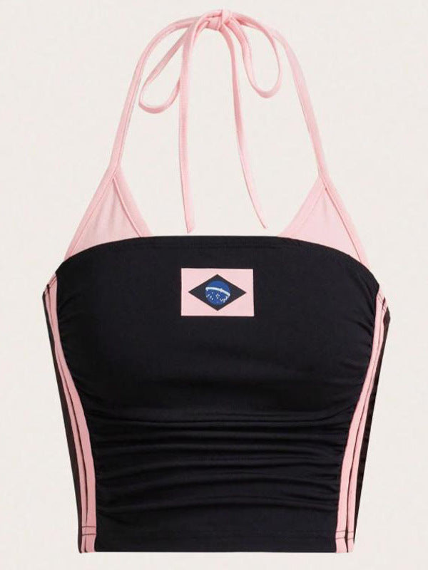 Pink and black halter crop top with side stripes and flag print flat lay