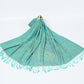 Jade green paisley shawl with turquoise tassels spread on a white background