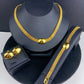 Imitation gold three-piece jewelry set seen from a side angle, polished gold-tone finish