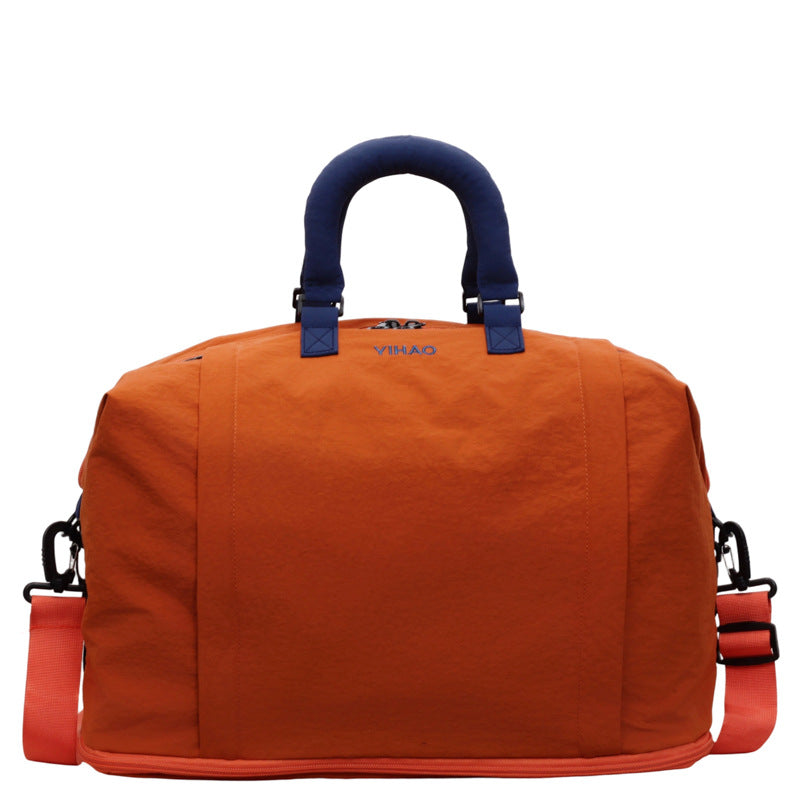 Travel duffel bag carried by the detachable crossbody strap on the shoulder