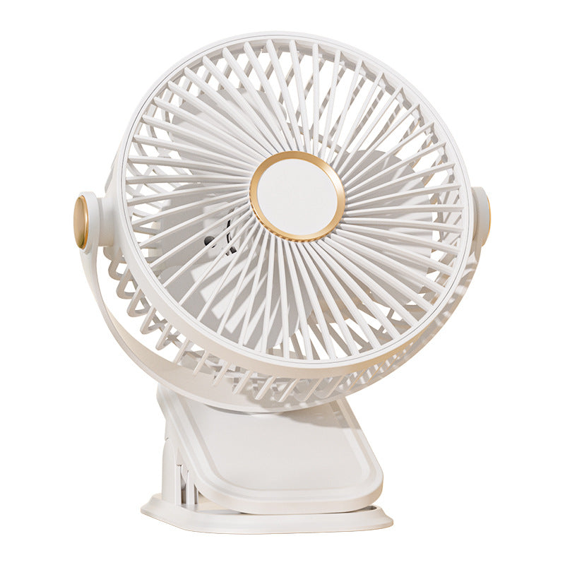 White clip fan on a plain background, three blades behind a round grille and gold hub ring