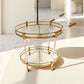 Close view of the gold stainless steel frame and clear acrylic legs of the serving cart