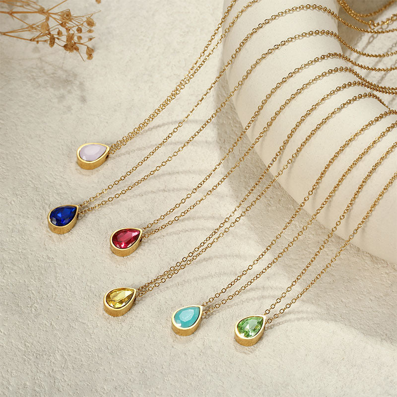 Six gold plated teardrop pendant necklaces with blue, pink, red, yellow and green stones