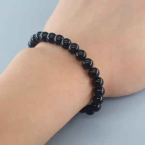 Side angle of the rose quartz tiger eye bracelet showing rounded polished stone beads