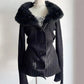 Black cardigan with plush collar and ribbed body on a mannequin, pearl necklace and plaid top for styling