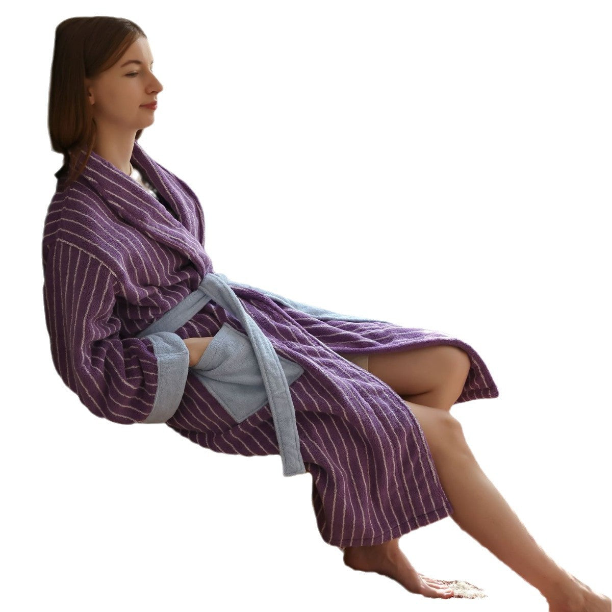 Purple striped cotton terry bathrobe with light blue trim worn seated, shawl collar and belt