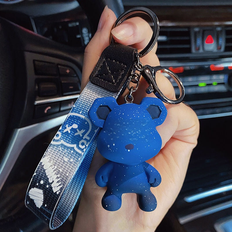 Silicone bear keychain with lobster clasp and metal split ring held in hand