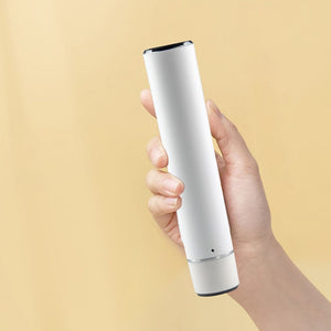 Hand holding the white cordless handheld vacuum sealer