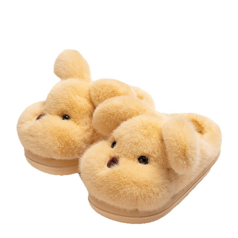 Pair of yellow puppy plush slippers with floppy ears and dark noses on a white background
