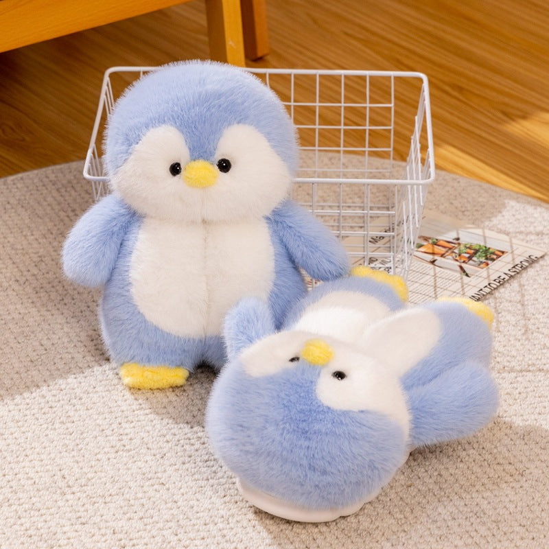 Blue plush penguin toy beside a blue penguin slipper on a wooden floor with a wire basket, Blue Full-Heel EU 38-39