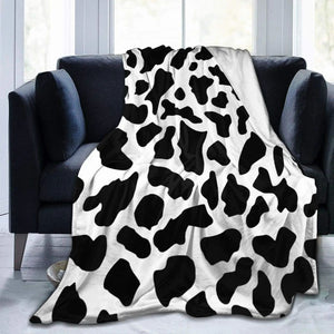 Throw blanket spread across a sofa with two cushions