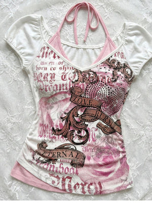 Flat lay of a white printed halter tee with pink neck ties and a baroque graphic