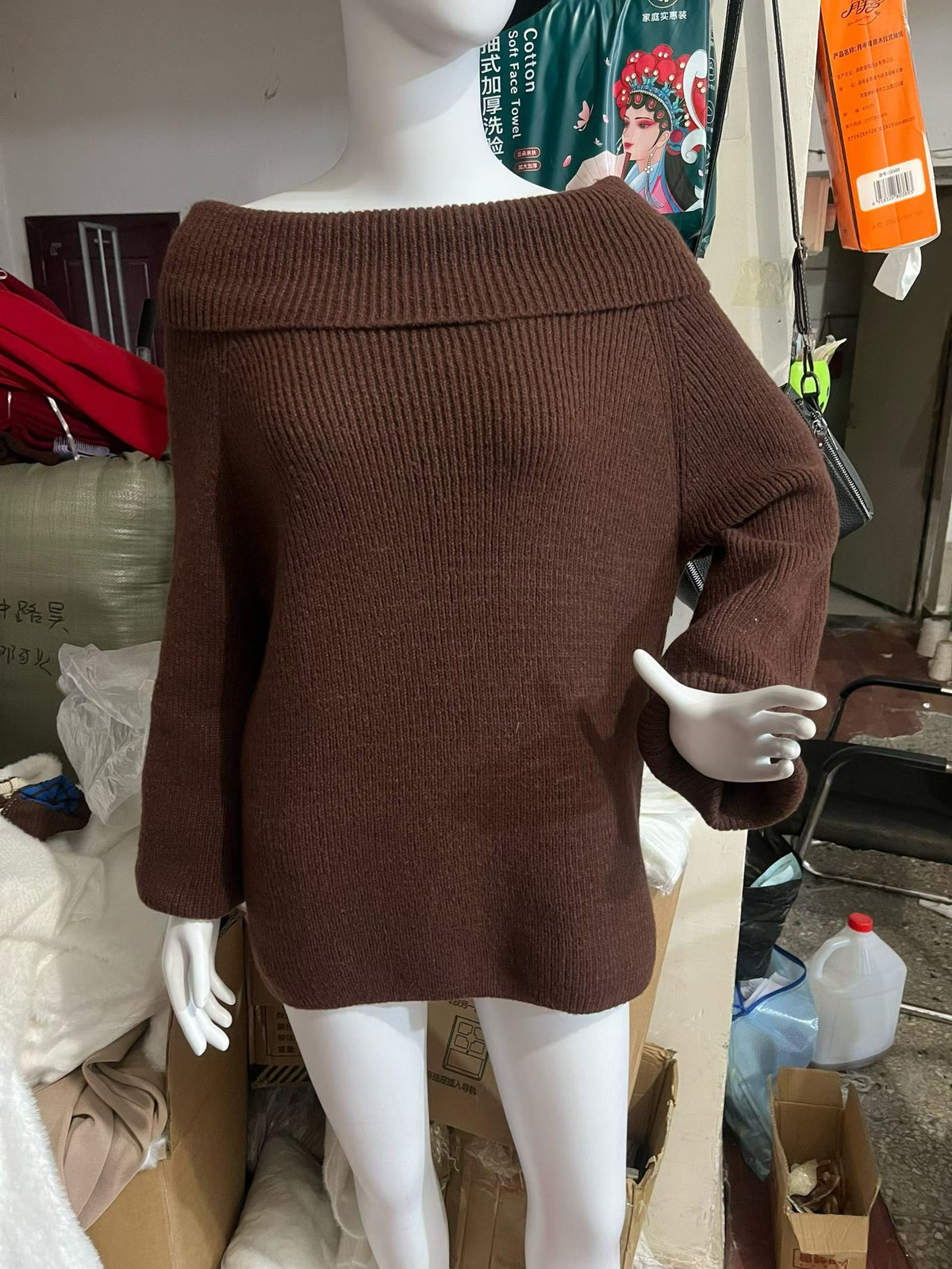 Brown off-shoulder fold-over knit sweater with wide sleeves shown on a mannequin