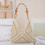 Woven straw shoulder bag holding a phone, wallet, sunglasses, and keys inside