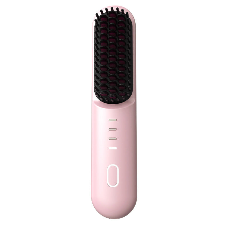 Pink cordless heated straightening comb with black ceramic teeth and a side power button, front view